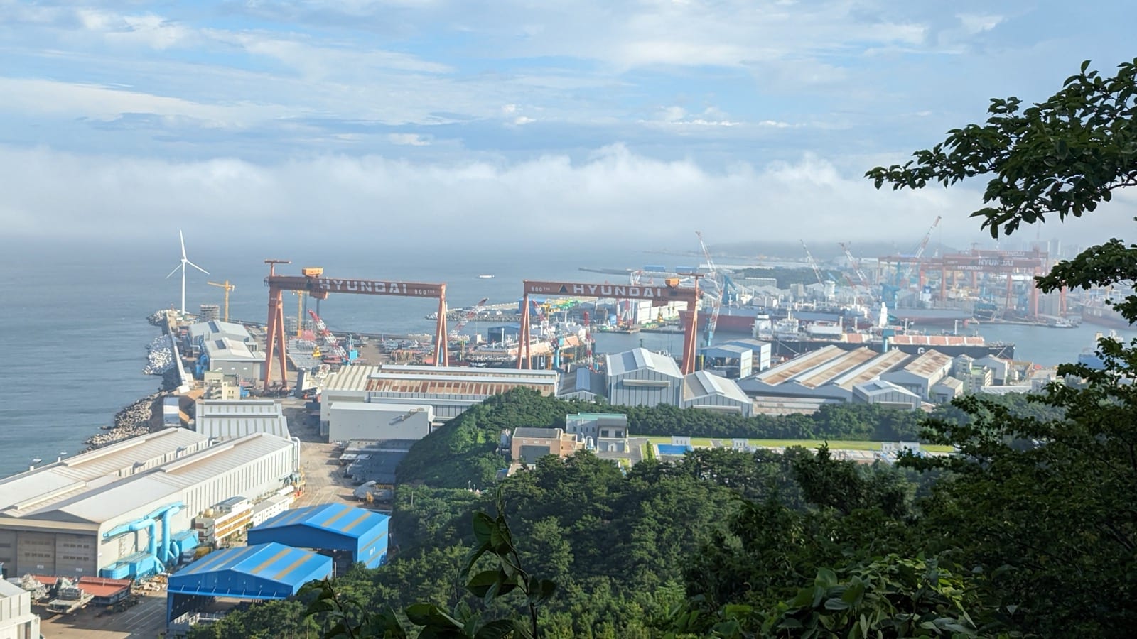 Shipyard goliath gantry crane lifting a hull section